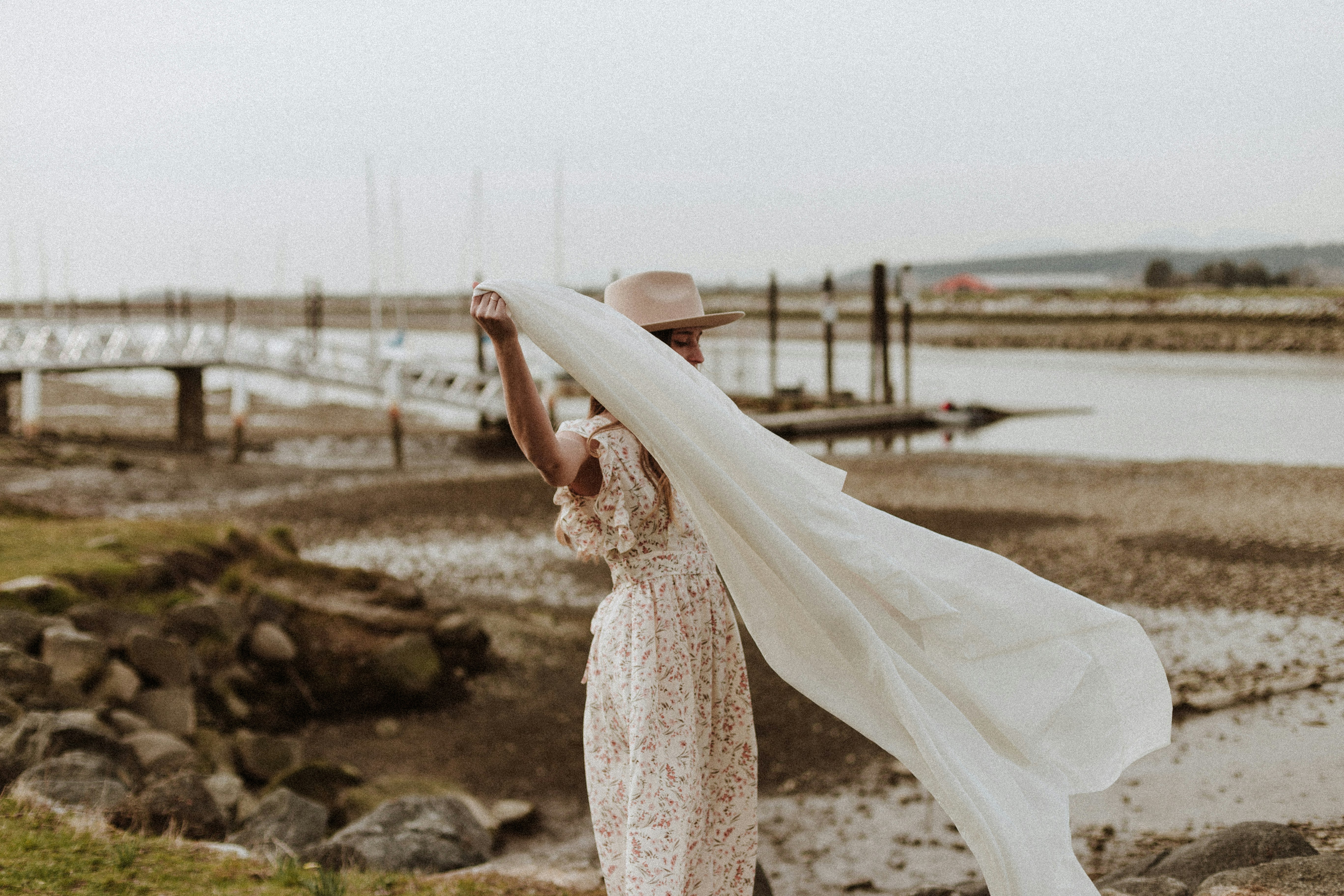 woman in white floral dress standing on rock during daytime